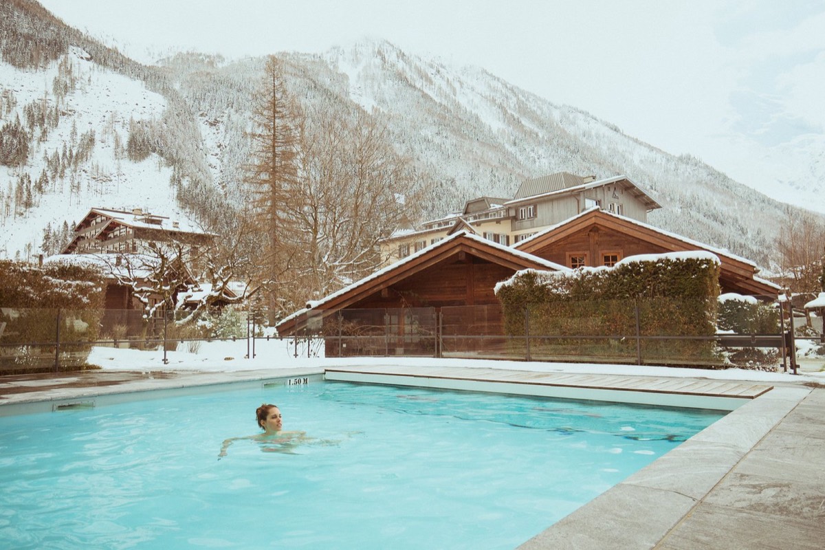 Outdoor pool under the snowy mountains